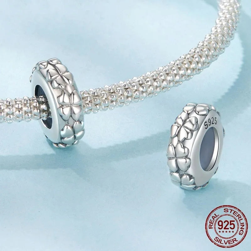 S925 sterling silver four-leaf clover positioning spacer bead with pearlescent finish on white background