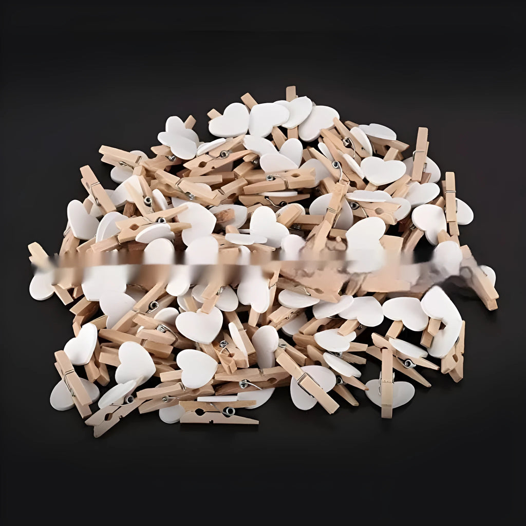 Set of five handmade wooden heart-shaped decorative clips in assorted colours.