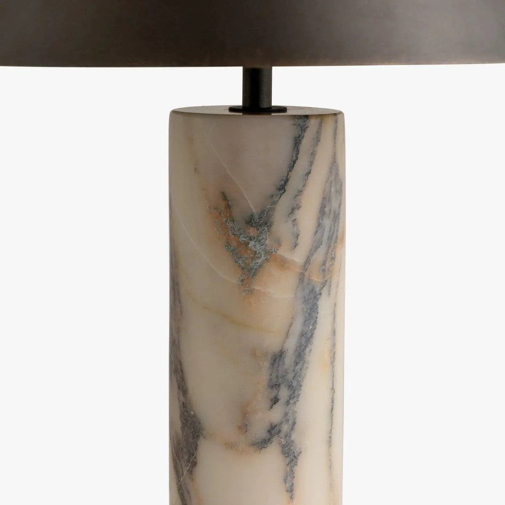 Modern black table lamp with a textured marble base on a wooden desk.