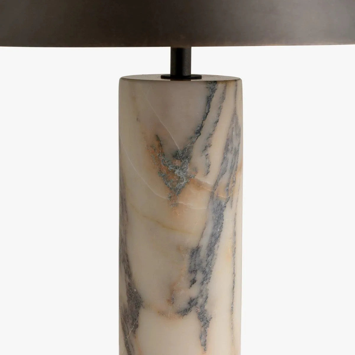 Modern black table lamp with a textured marble base on a wooden desk.