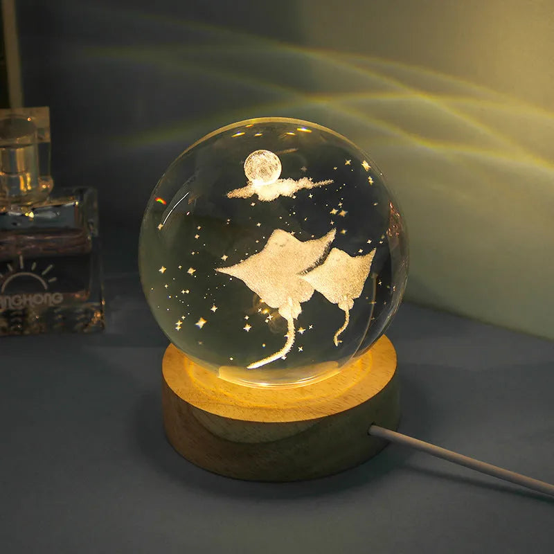 Transparent crystal ball night lamp with 3D carved jellyfish design, on a round base with USB cable.