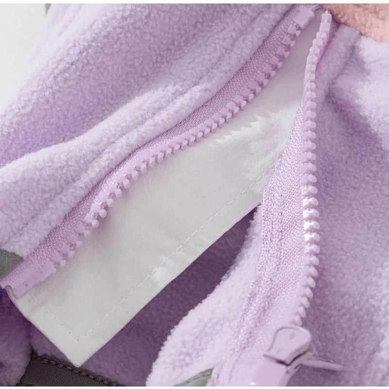 Four-legged fleece jacket for cats and small dogs in colour block design with badge patch, showing front zipper and elastic cuffs.