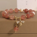 Women's bracelet with strawberry quartz stones, freshwater pearls, and zircon on an alloy chain.