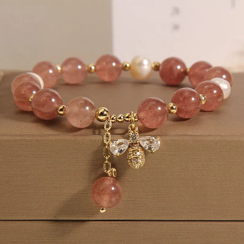 Women's bracelet with strawberry quartz stones, freshwater pearls, and zircon on an alloy chain.