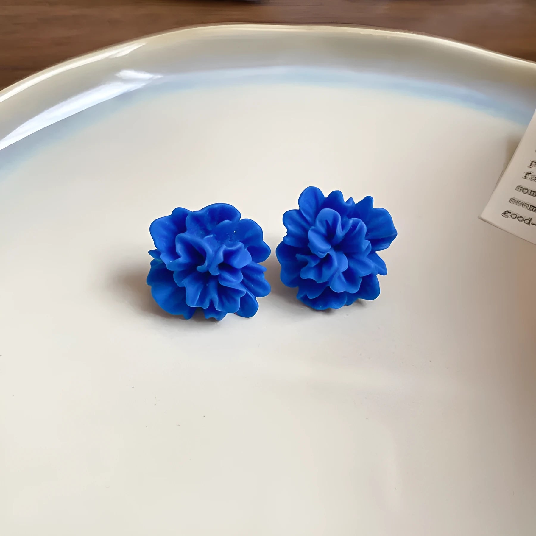Geometric women's earrings made from blue and silver cloth with round design elements.