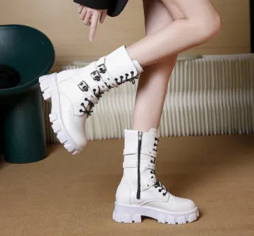 Black women's mid-calf boots with metal buckles and a side zip on a white background.