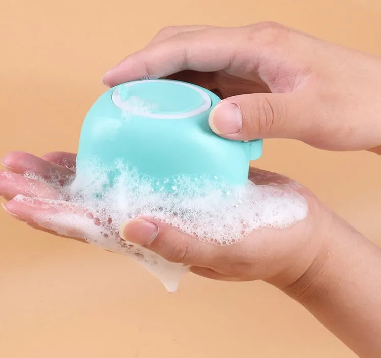 Silicone dog bath brush in blue with flexible bristles for gentle grooming and bathing.