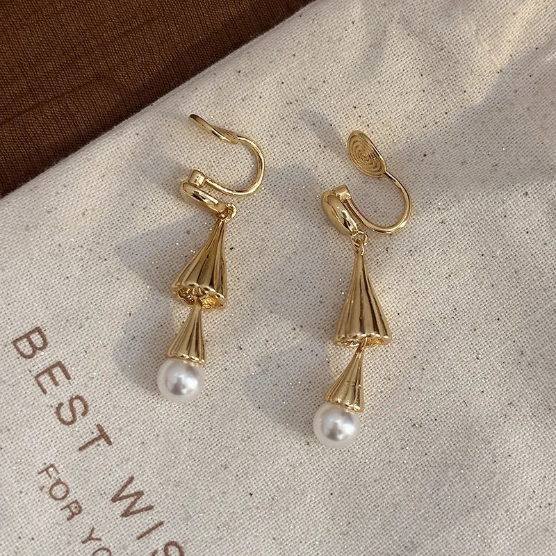 Gold geometric fringe ear clip earrings with long wind chime mosquito coil plate design on copper base