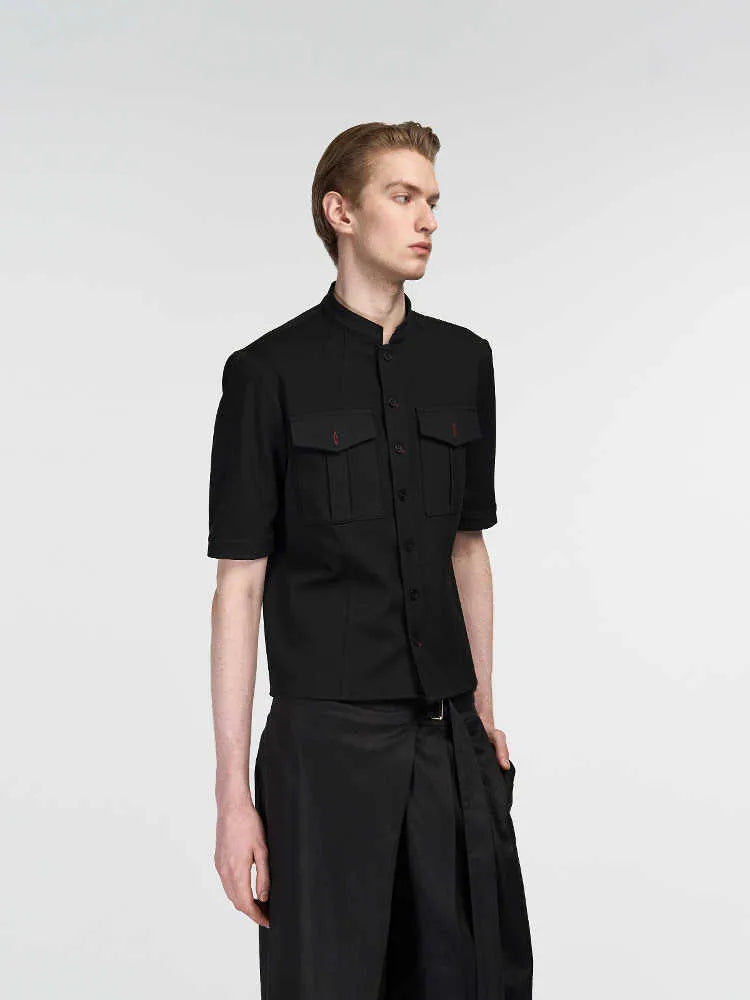 Handmade black half-sleeve hunting shirt with a shirt collar and single-breasted placket on a hanger.