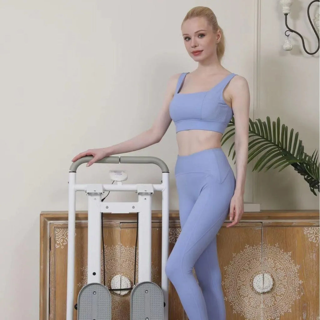 White folding treadmill with attached indoor climbing frame for home fitness.