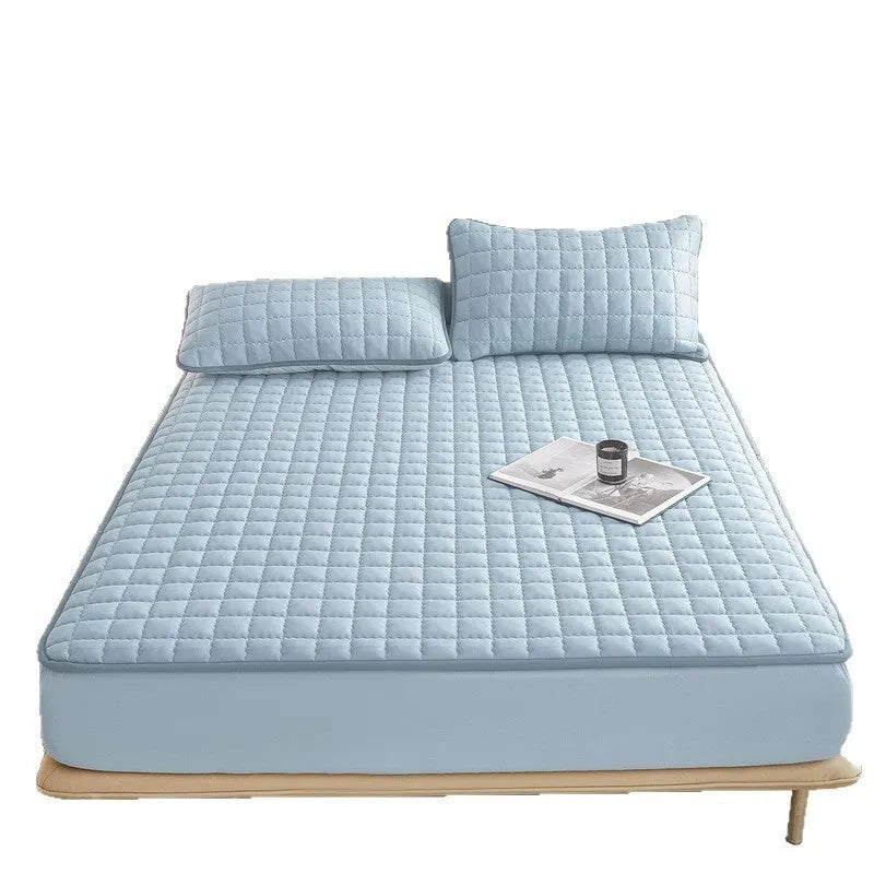 Class A waterproof washed cotton fitted sheet in blue on a bed.