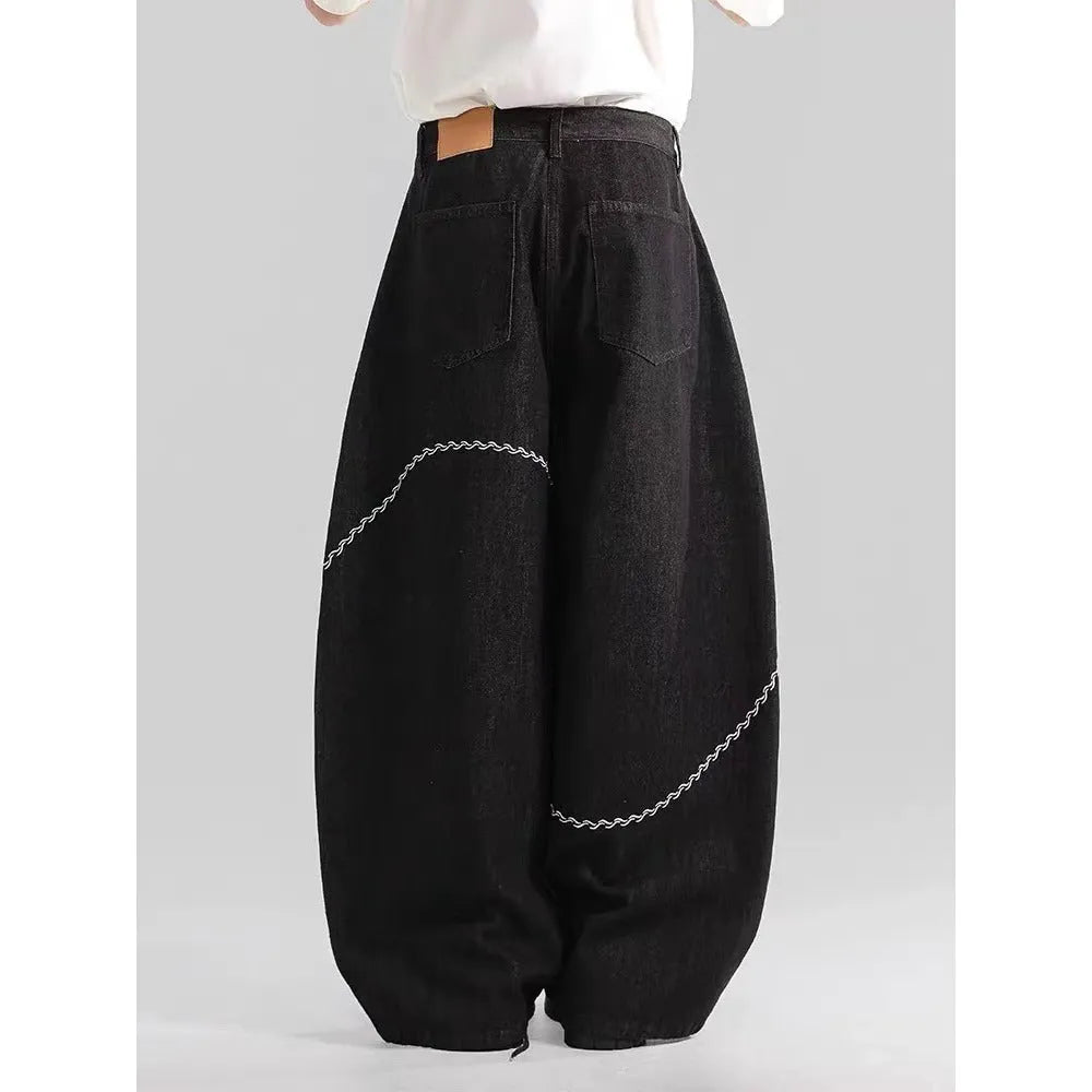 Black straight-leg denim trousers with micro-elastic waist and zip fly closure