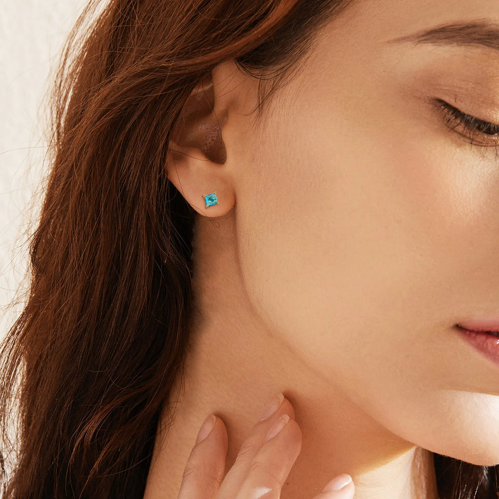 Brass gold-plated drop earrings with pear-shaped zircon stones in a candy colour.