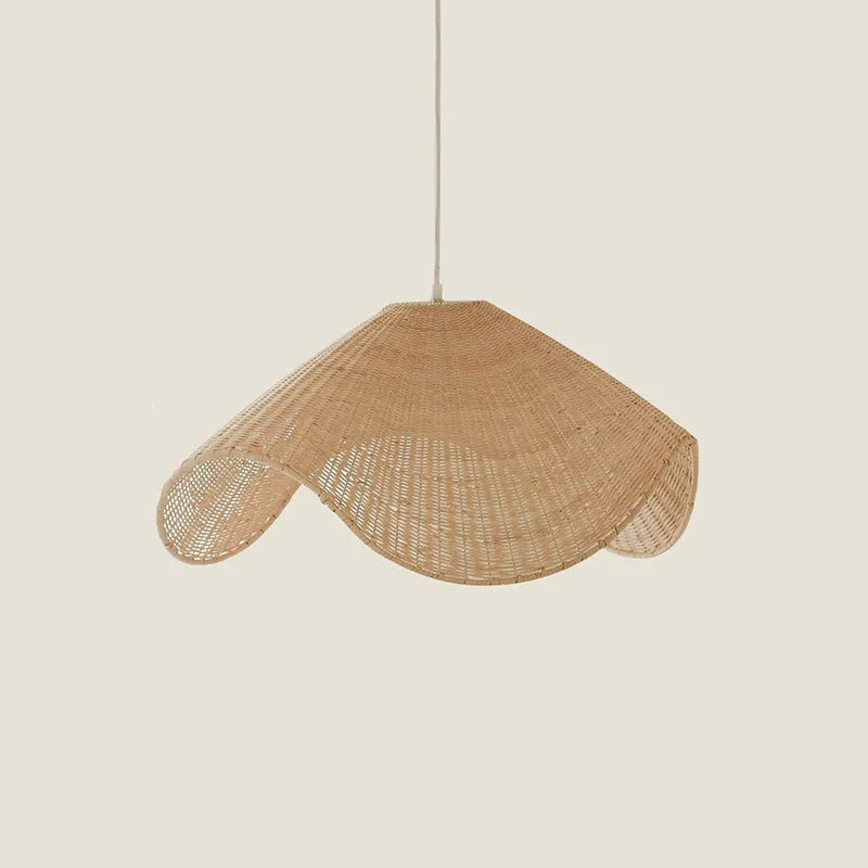 Handmade bamboo and straw rattan chandelier ceiling light with warm LED illumination in a rustic setting.