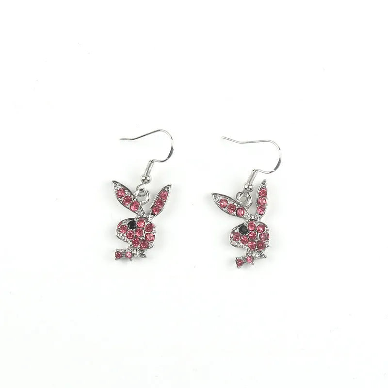 A pair of sparkling rabbit-shaped stud earrings with a full pavé cubic zirconia setting on a silver metal background.