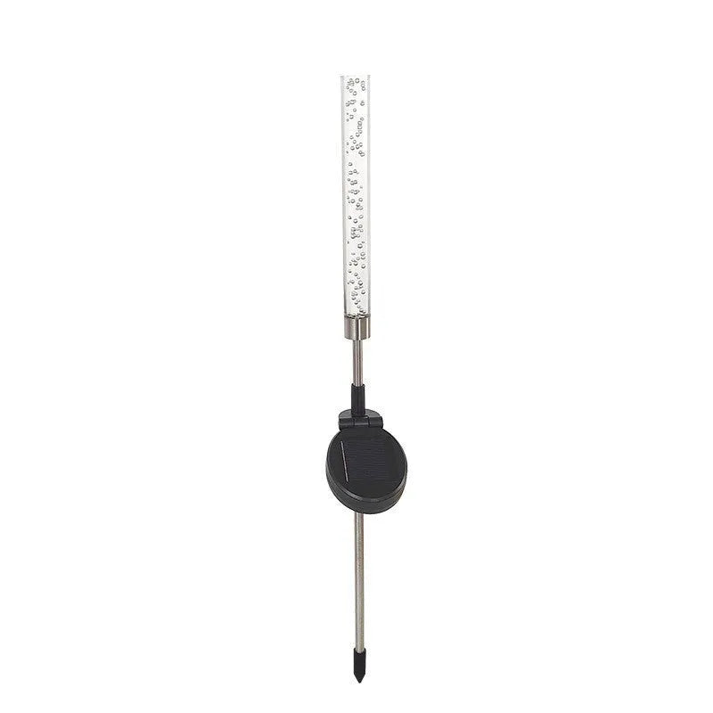 Solar bubble stick lawn lamp with colourful slow-flash crystal effect and warm light on a garden lawn