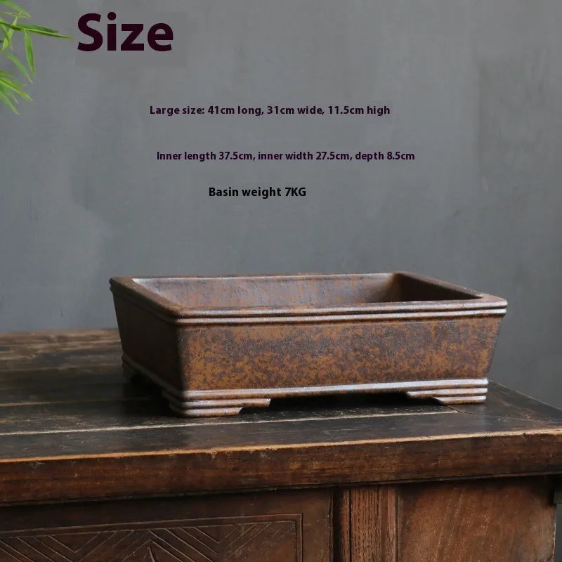 Rectangular purple sand bonsai pot on floor, showing simple five-line basin design.