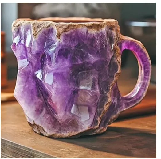 A purple resin coffee mug with a handle, showing a crystal-like structure, on a table.