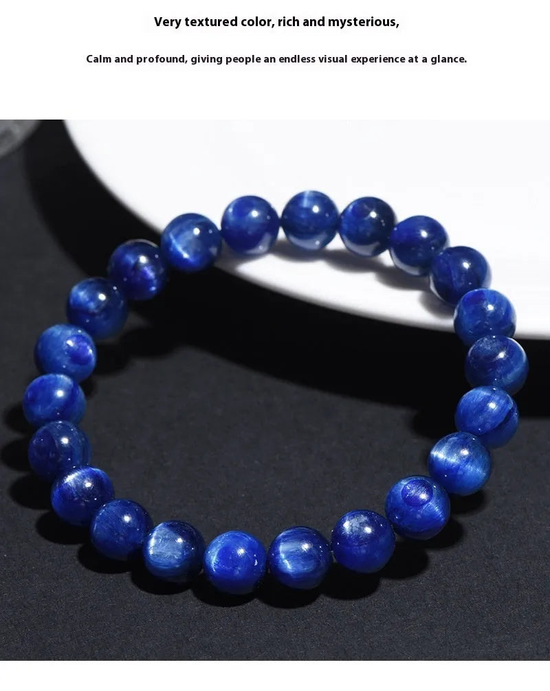 Blue crystal ball bracelet with geometric beads and a Ruyi charm on a white background.