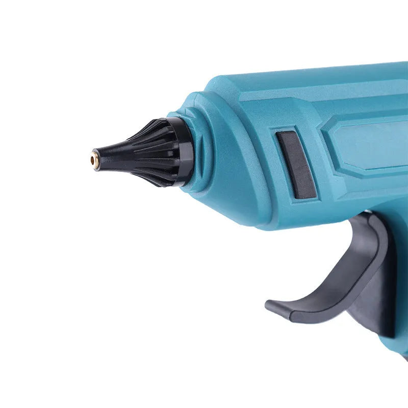 Rechargeable hot melt glue gun with lithium batteries and glue sticks on work surface