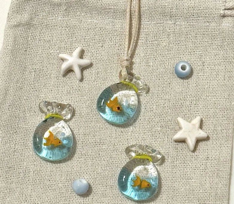 Women's necklace with a colourful skirt joker pendant on a long, braided cotton and linen chain.