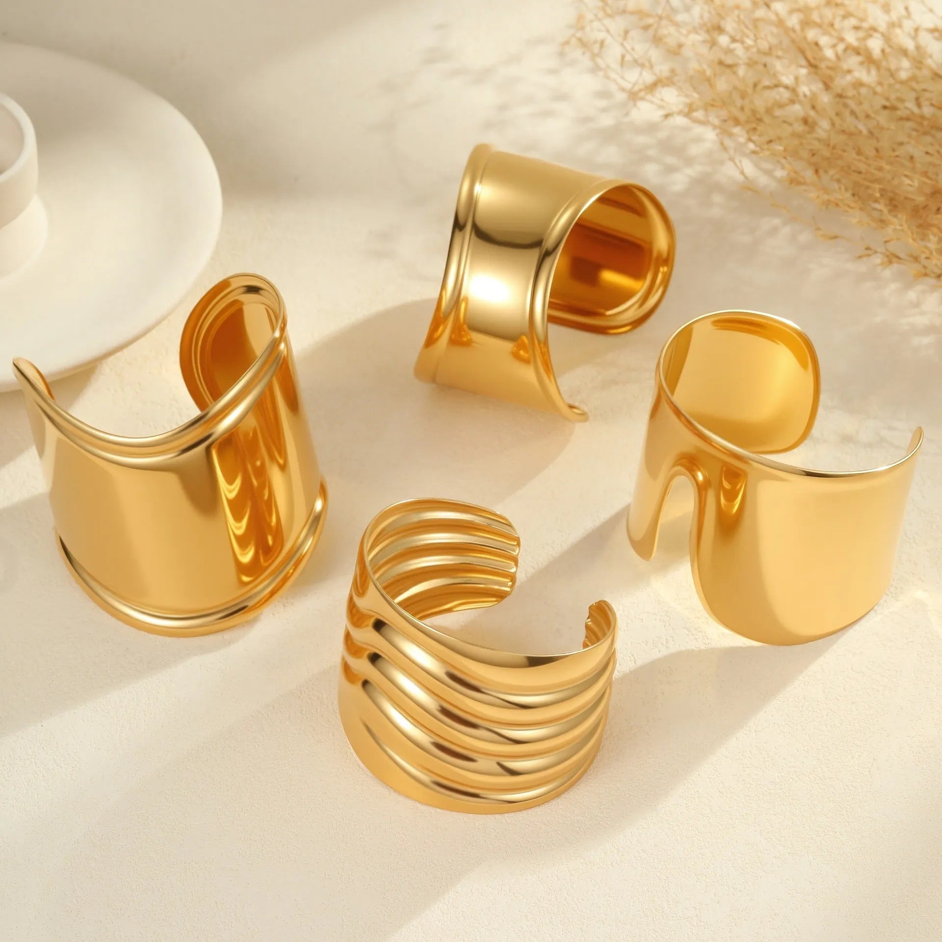 Women's wide geometric wave bracelet with gold plating and niche opening detail on wrist