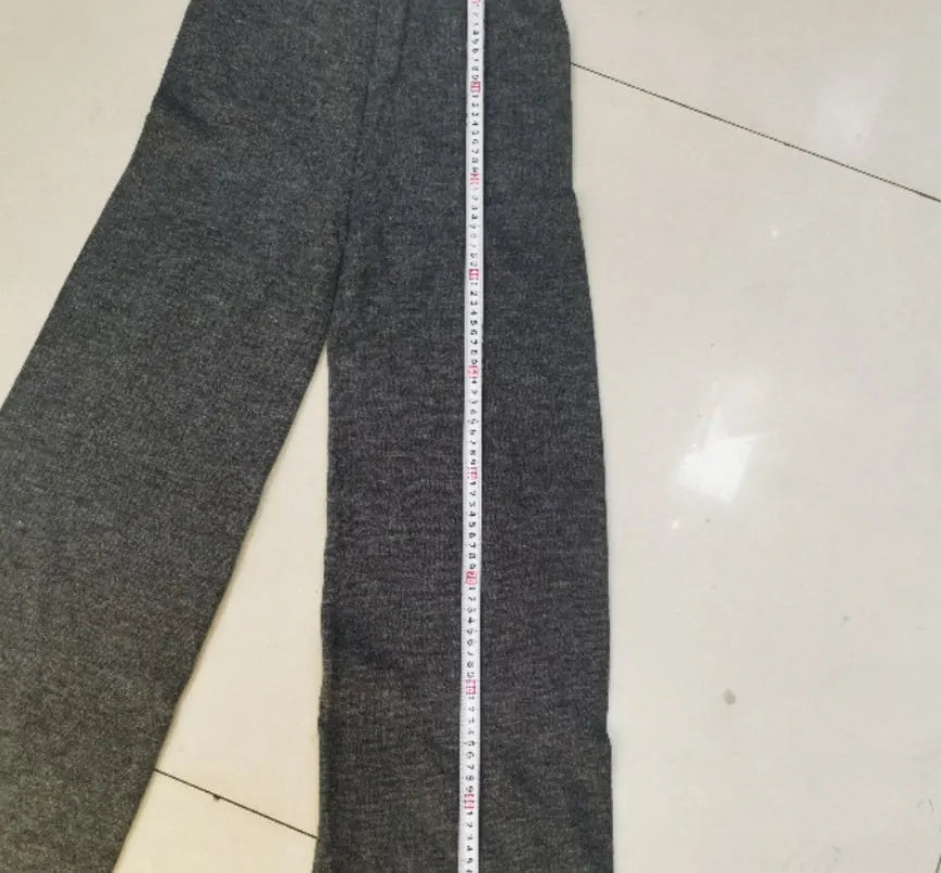 Dark grey women's knitted side-slit top and matching trousers set on a hanger