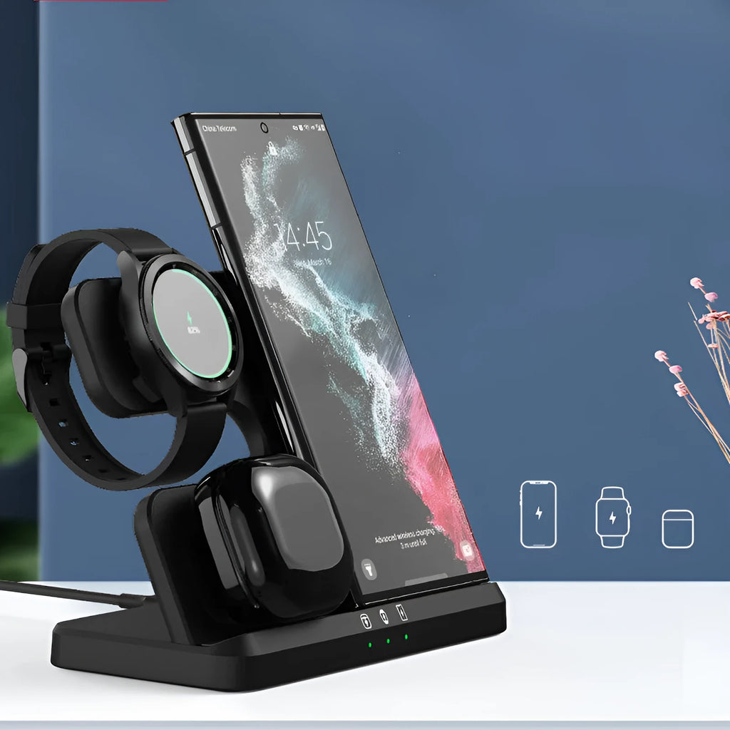 A vertical 3-in-1 wireless charging stand holding a mobile phone, a smartwatch, and headphones on a desk.