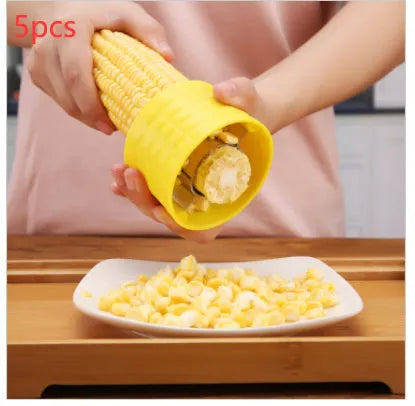 Yellow manual corn grinder thresher kitchen gadget with corn kernel shaped handle.