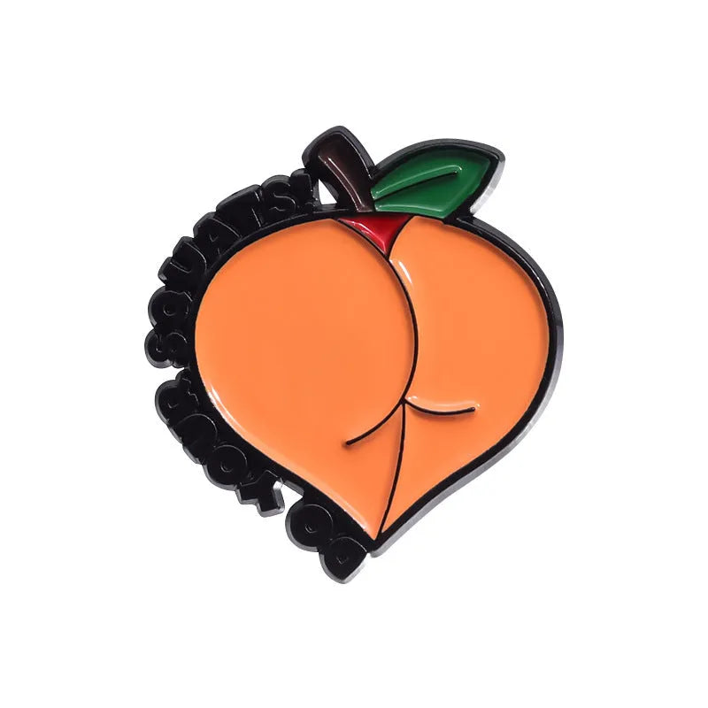 Close-up of a colourful cartoon strawberry metal brooch with a safety-pin clasp, on a denim jacket pocket.