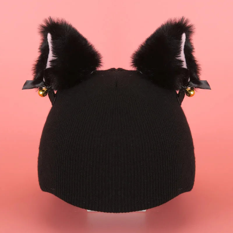 A plush fabric helmet cover with cartoon print and 3D ears, next to a matching beanie hat, on a neutral background.
