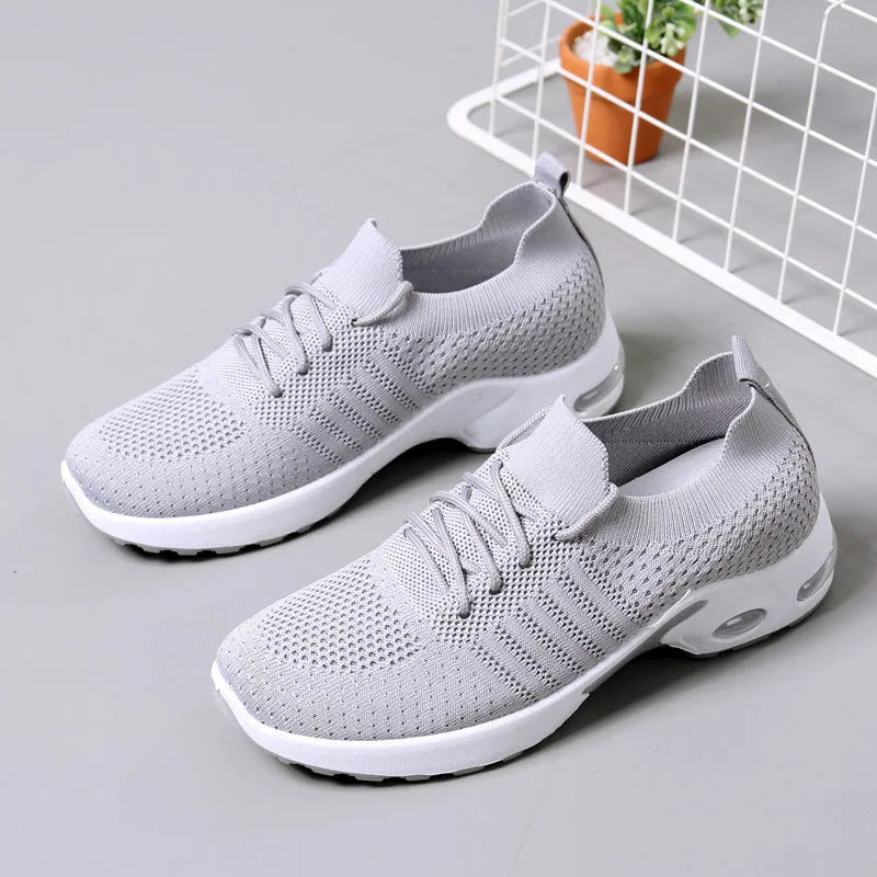 Women's black mesh lace-up casual sneakers with a round toe and non-slip sole on a white background.