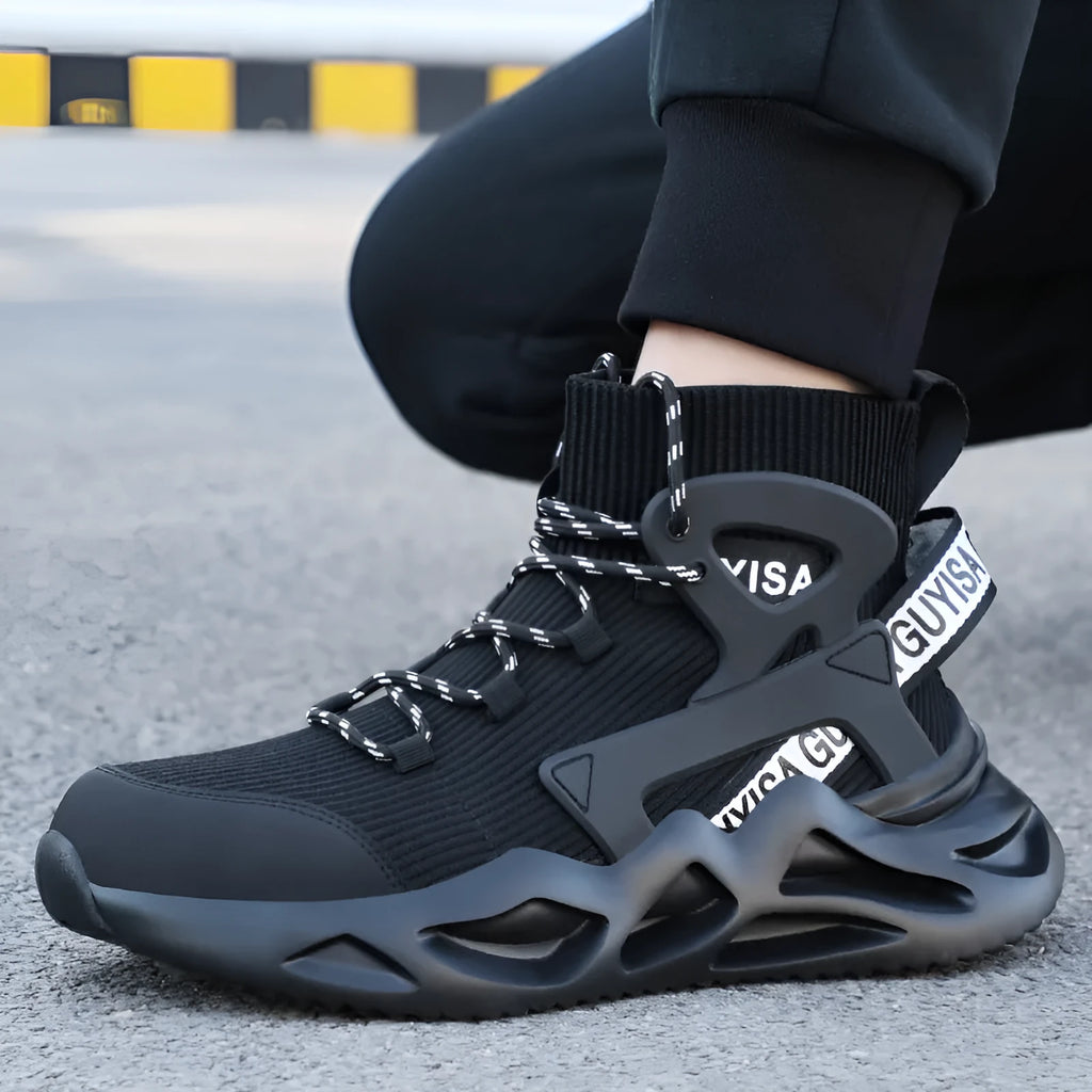 Men's black and white steel toe cap safety work shoes with fly woven mesh upper and rubber sole on concrete floor