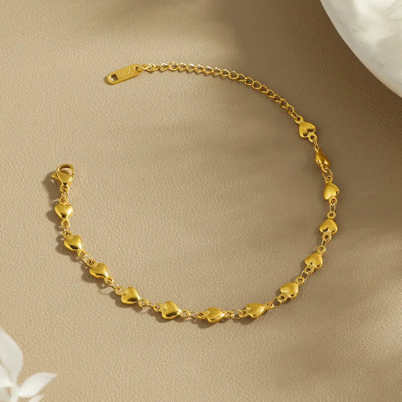 Titanium steel gold chain heart bracelet electroplated colour for women on white background