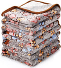 Coral fleece pet blanket with dog's paw print pattern in beige, shown in a large size on a dog bed.