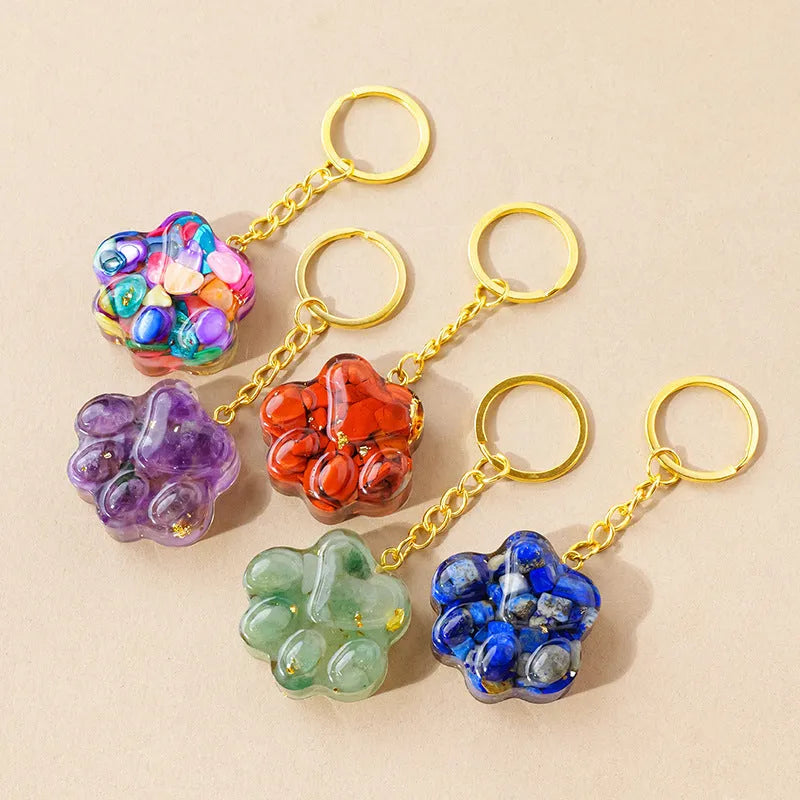 Natural crystal cat's paw shape pendant on a metal keyring, showing example of polished stone like turquoise or amethyst.