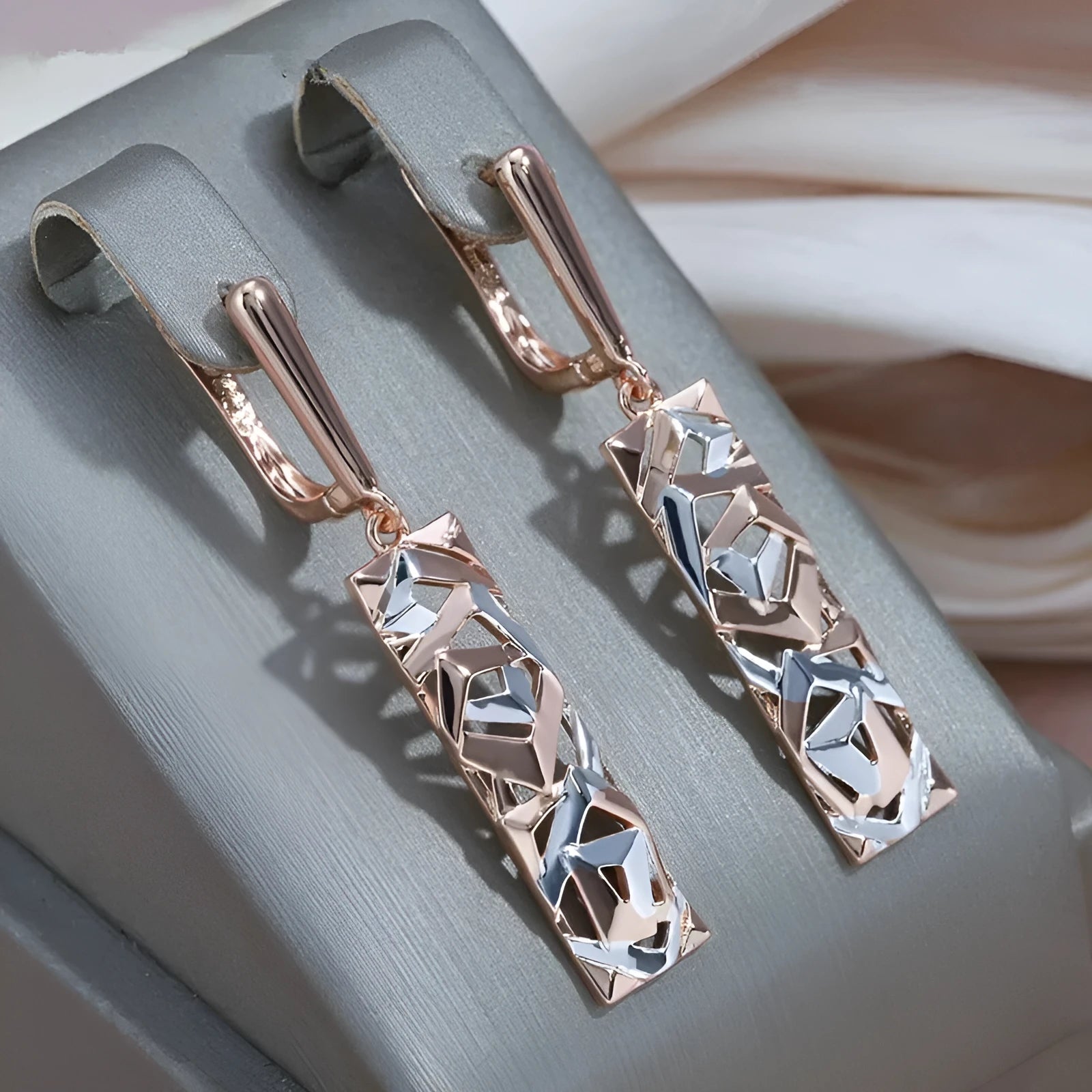 Rectangular two-tone hollow stud earrings with electroplated finish and geometric design