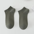 A pair of solid-colour, low-cut boat socks for men made from breathable polyester, shown in one of the six available shade options.