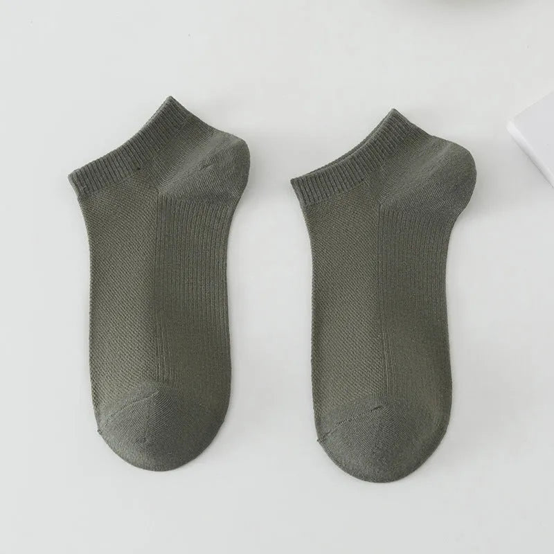 A pair of solid-colour, low-cut boat socks for men made from breathable polyester, shown in one of the six available shade options.