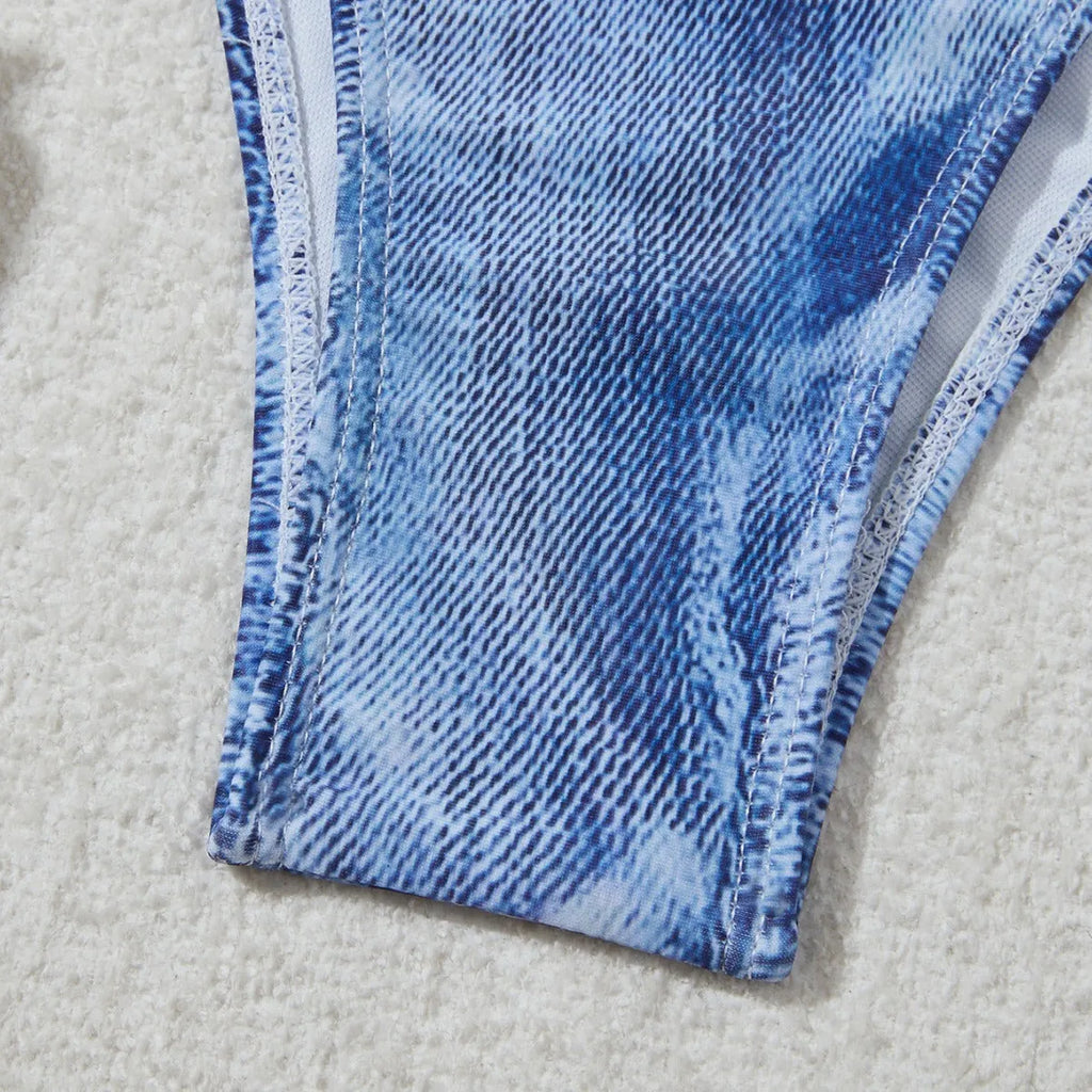 Women's denim blue printed bikini set with adjustable straps on a mannequin.