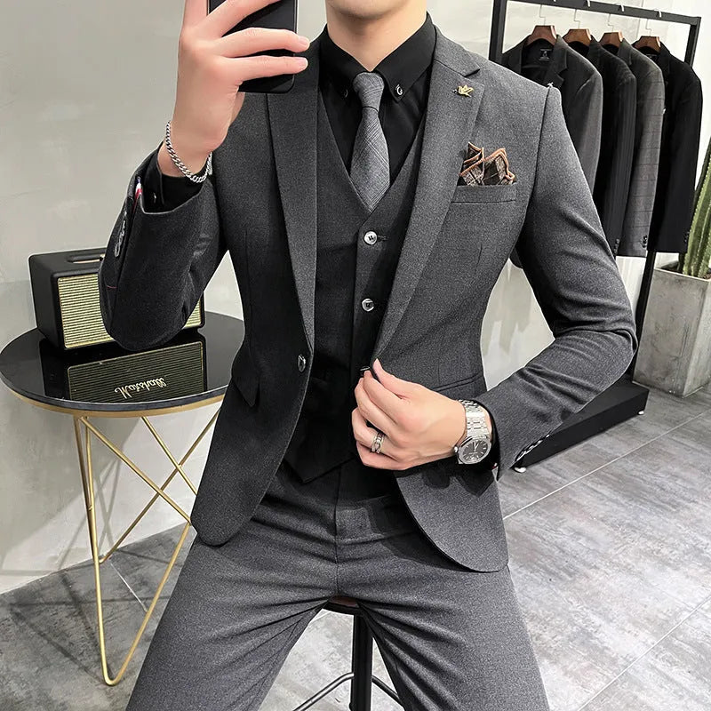 Three-piece men's acetate fibre blend business suit set in light gray with jacket, trousers, and vest.