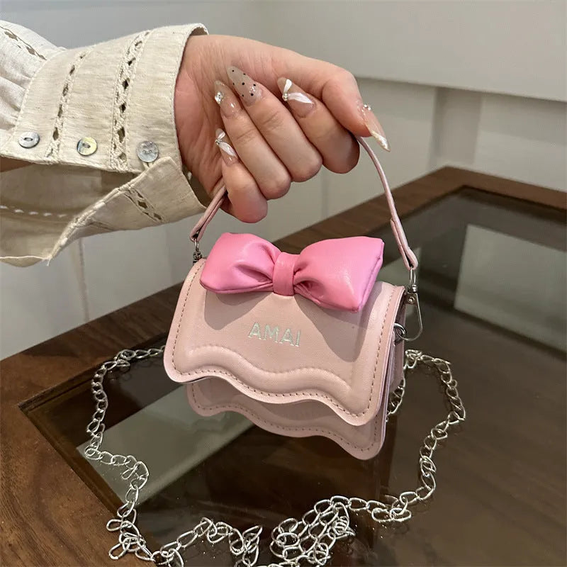 Mini crossbody bag in seven colour options with single shoulder strap and structured PU construction