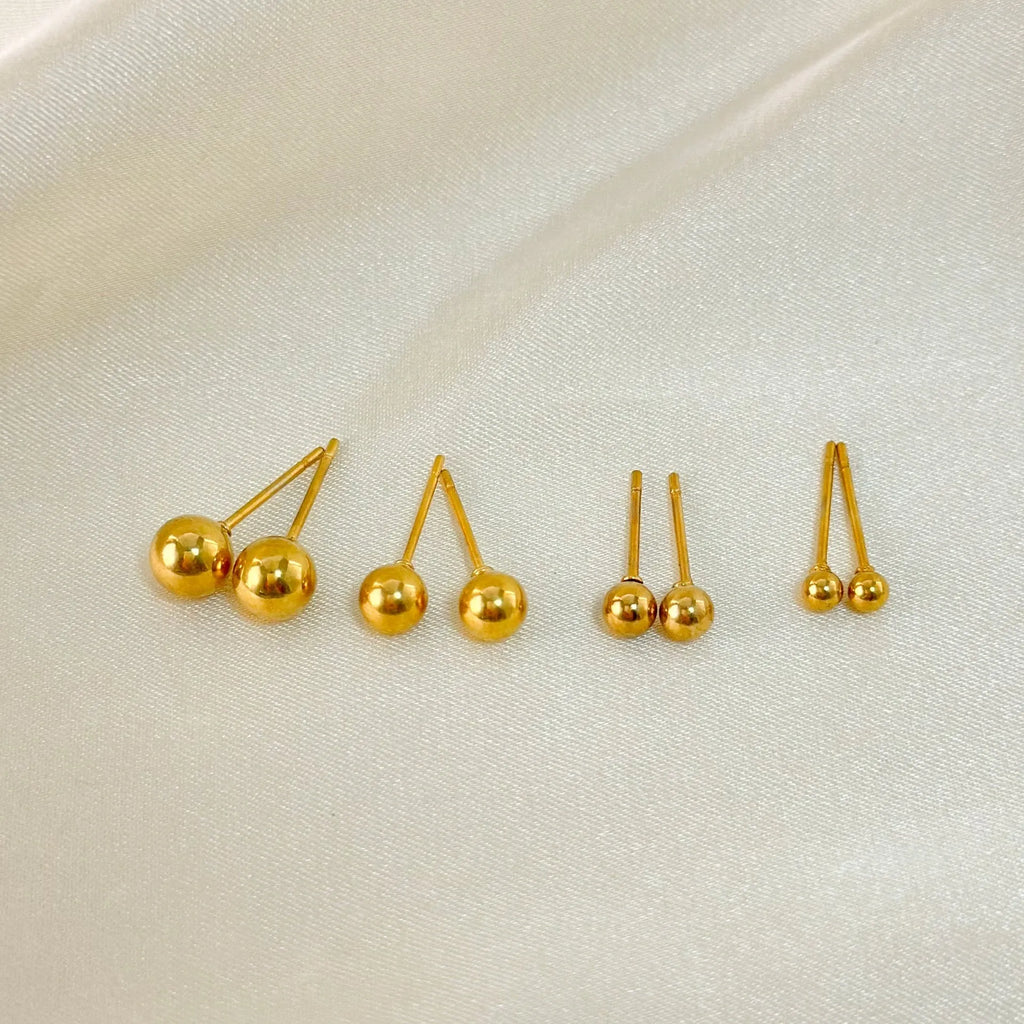 Minimalist stainless steel ball stud earrings in gold or silver, showing 3mm, 4mm, 5mm, and 6mm size options.