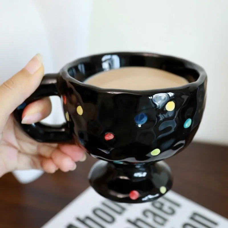Hand-pinched irregular shaped ceramic mug in a solid colour on a plain background.