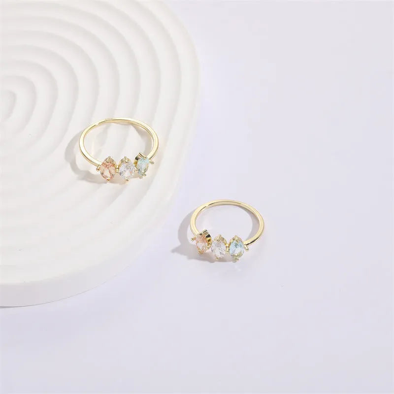 Mother's Day birthstone ring with geometric triangle design and horse eye tricolour zircon stones in 14k gold colour