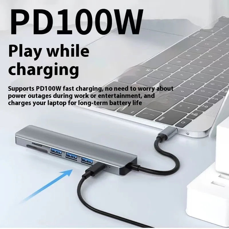 Silver USB-C 7-in-1 expansion dock with HDMI, USB ports, card slots, Ethernet, and a 15 cm cable.