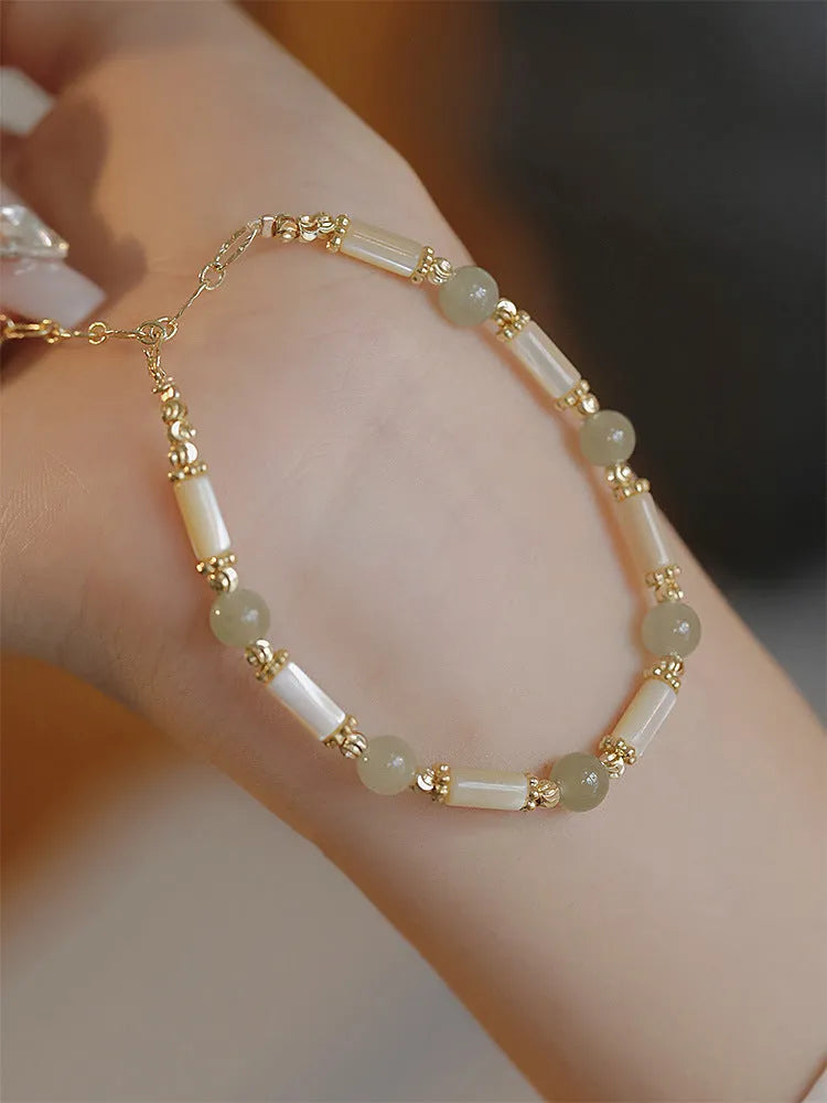 Casual women's bamboo joint bracelet made from 6mm Hetian jade beads in jade or red.