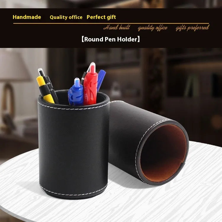 Black leather round pen holder on a desk