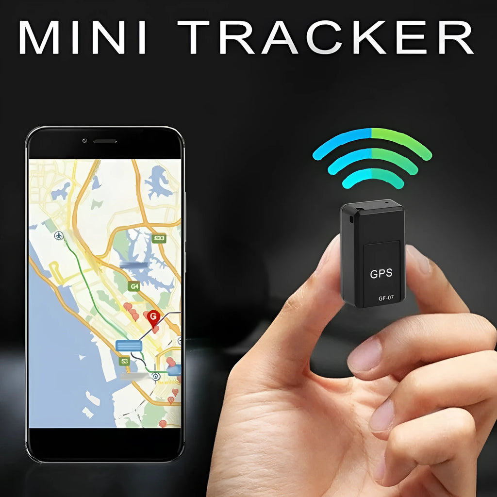 Small black magnetic GPS tracker device next to a micro-USB cable on a table.