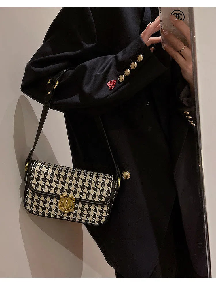 Women's houndstooth canvas baguette shoulder bag with adjustable strap on model